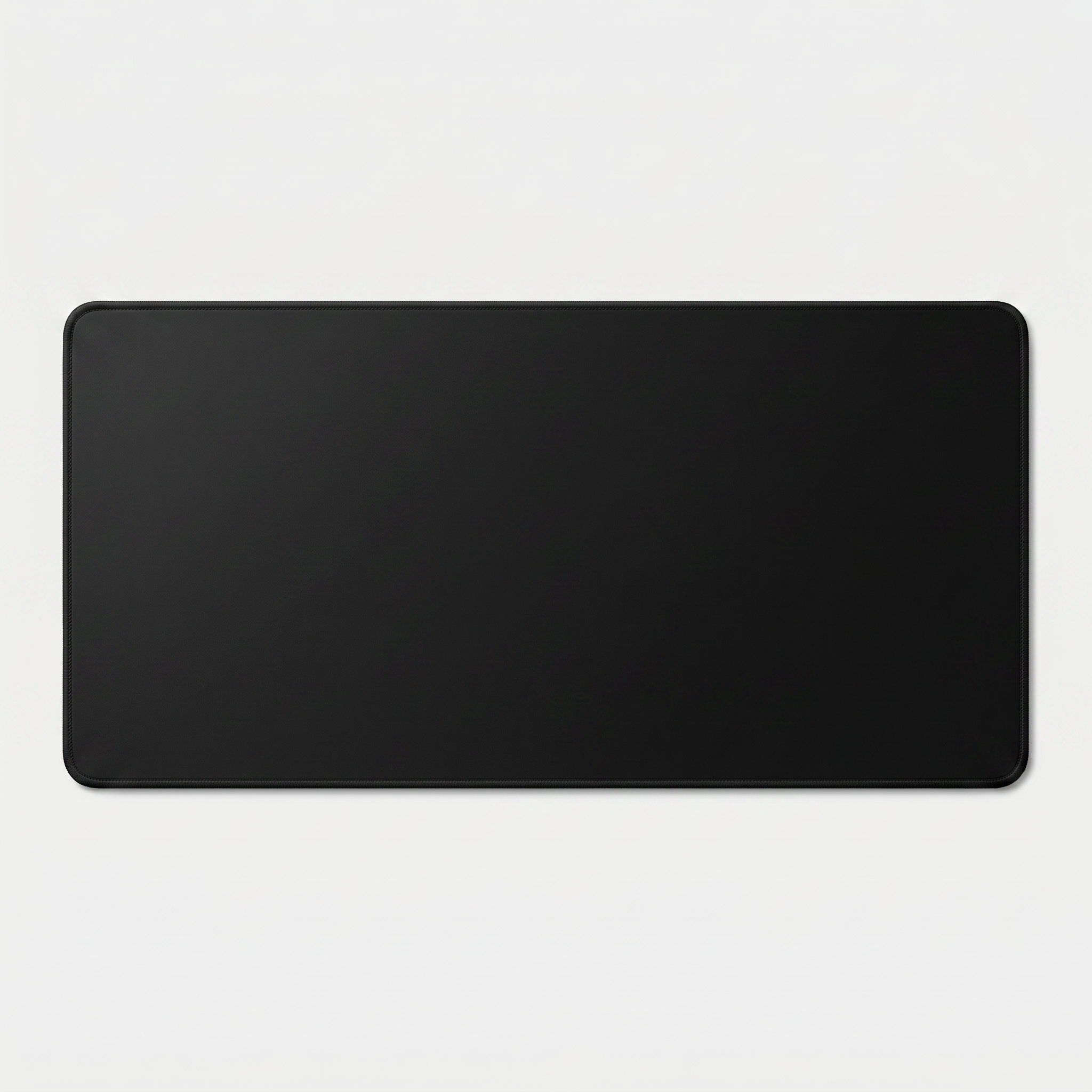 Extended XL desk mat in black with stitched edges on grey studio background