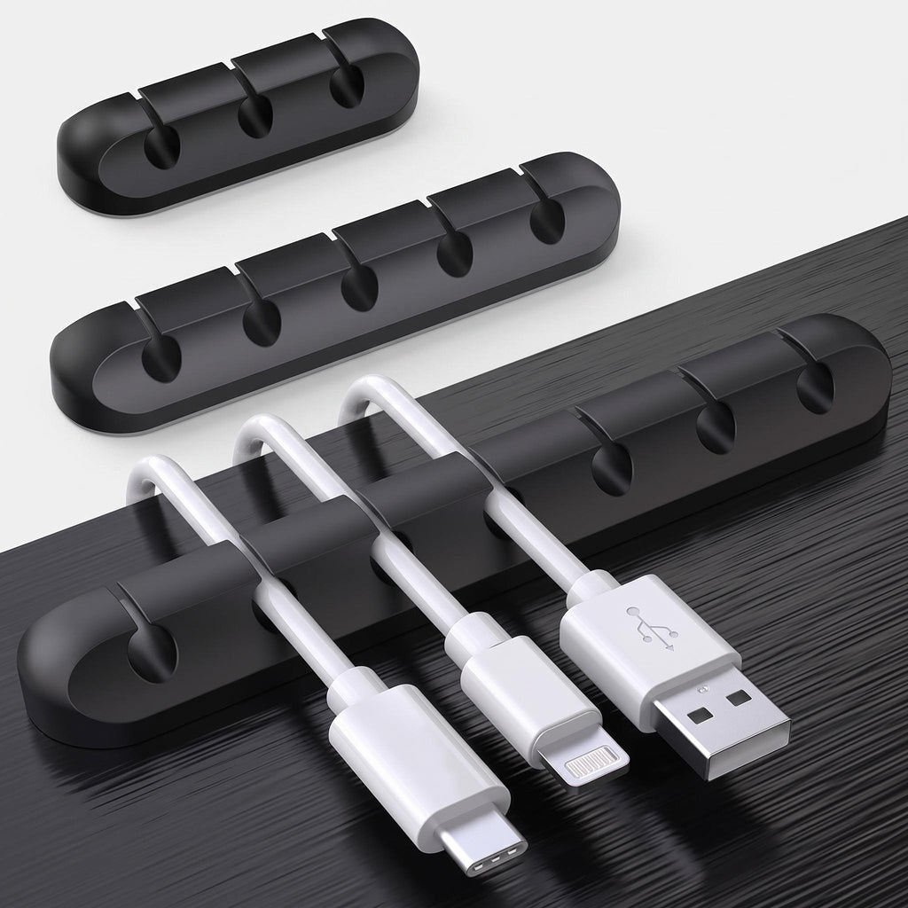 Black cable clips organising cables under desk edge