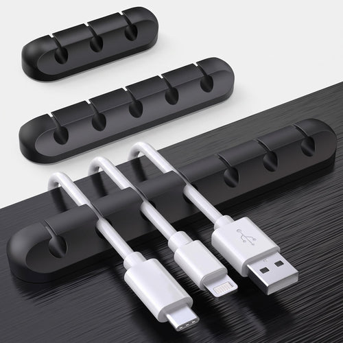 Black cable clips organising cables under desk edge