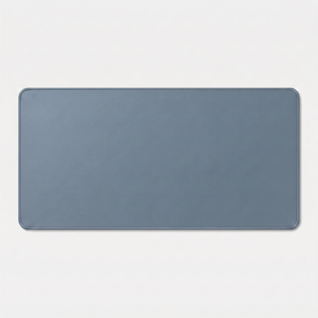 Sky blue extended desk mat on wood desk with keyboard and mouse