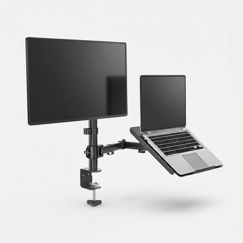 Monitor arm with laptop tray holding laptop beside mounted monitor